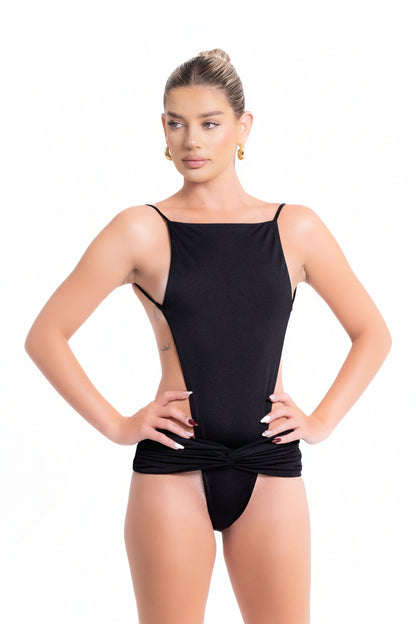 Woman wearing a black swimsuit on a white background