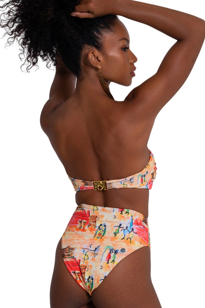 Woman wearing a colorful bikini with a white background