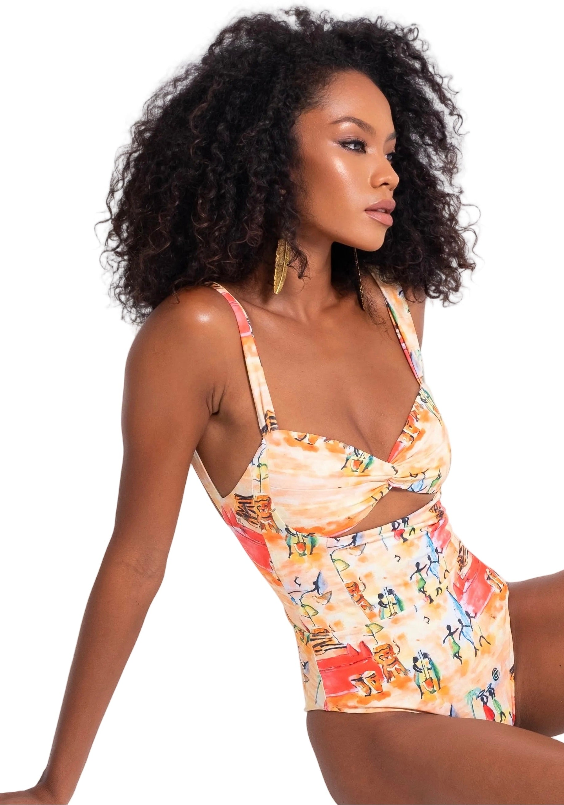 Woman wearing a colorful floral swimsuit on a white background