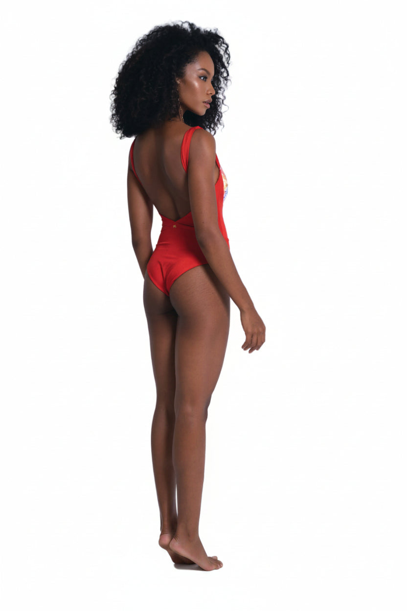 Woman wearing a red swimsuit with a white background